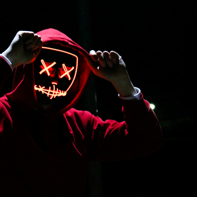 Haunt actor in red hood following haunt safety procedures